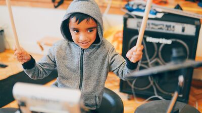 Young boy playing the drums